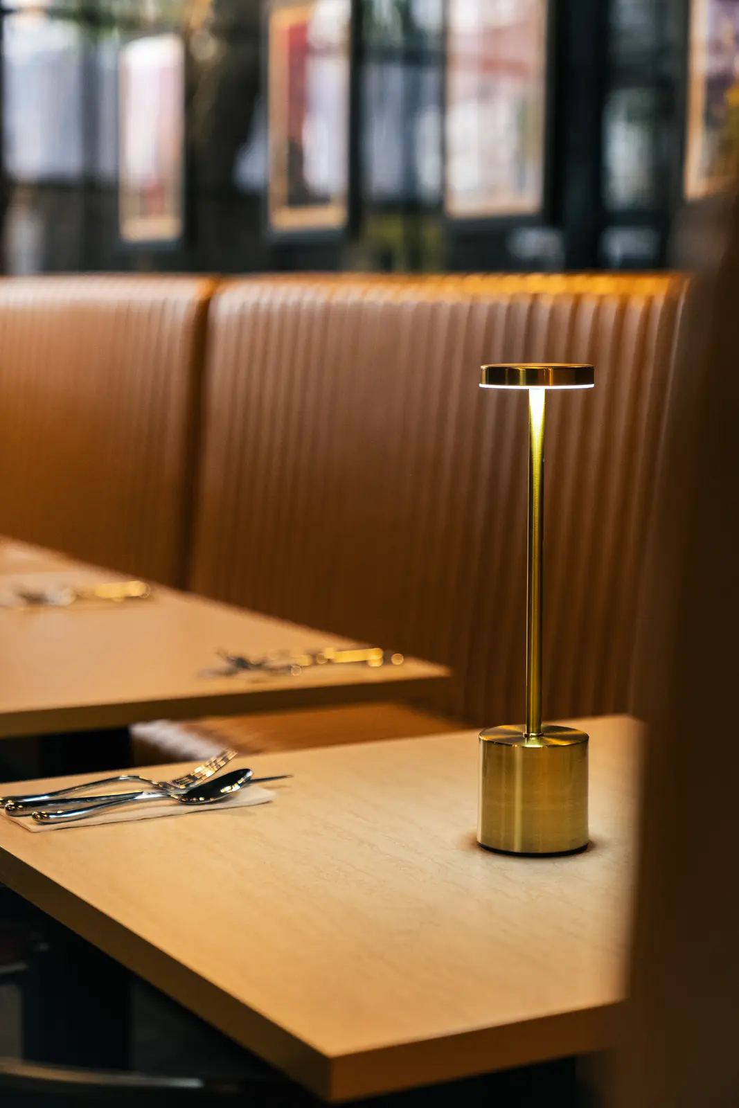 A private banquette booth with brass table lamp