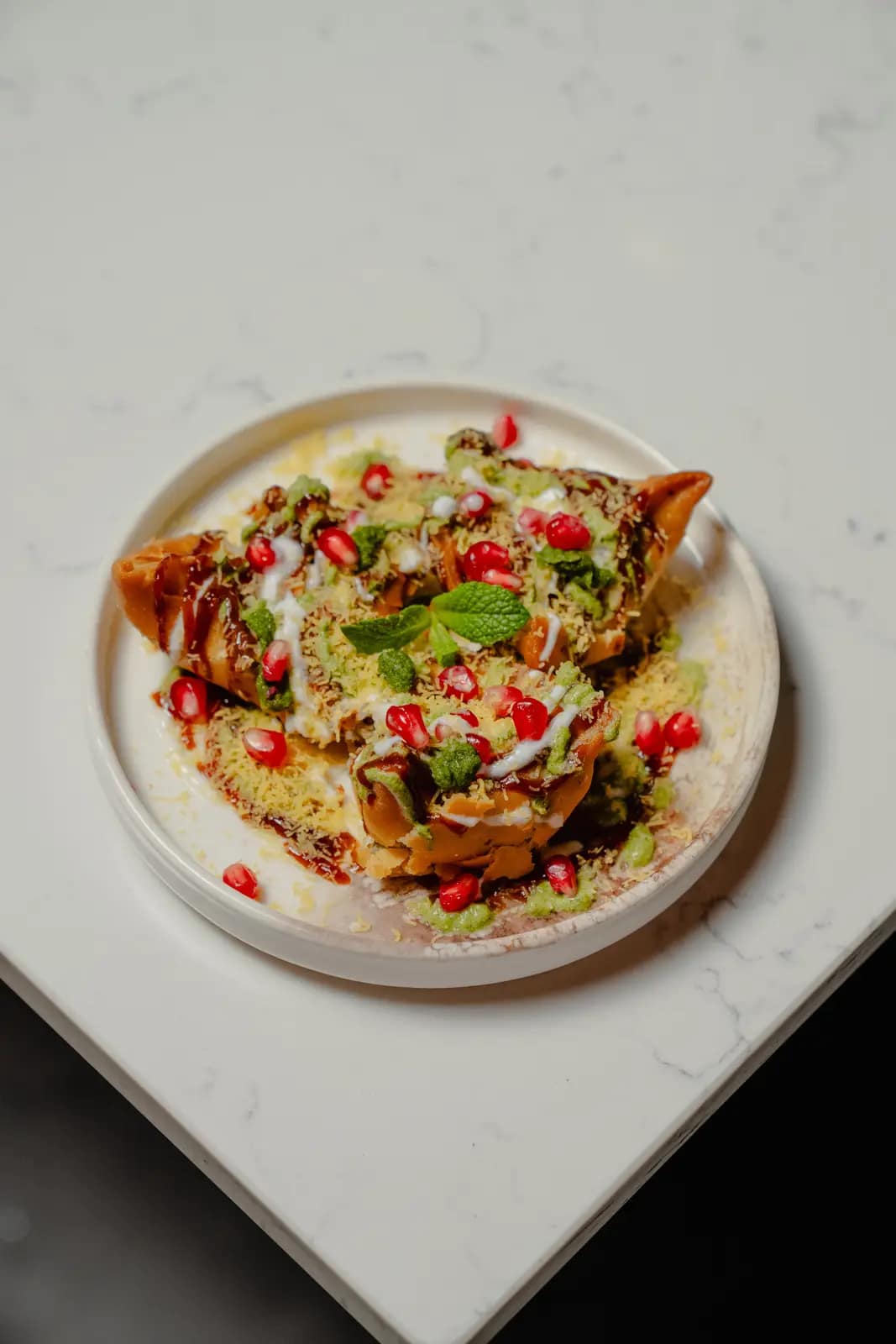 A plated street-food chaat finished with chutneys