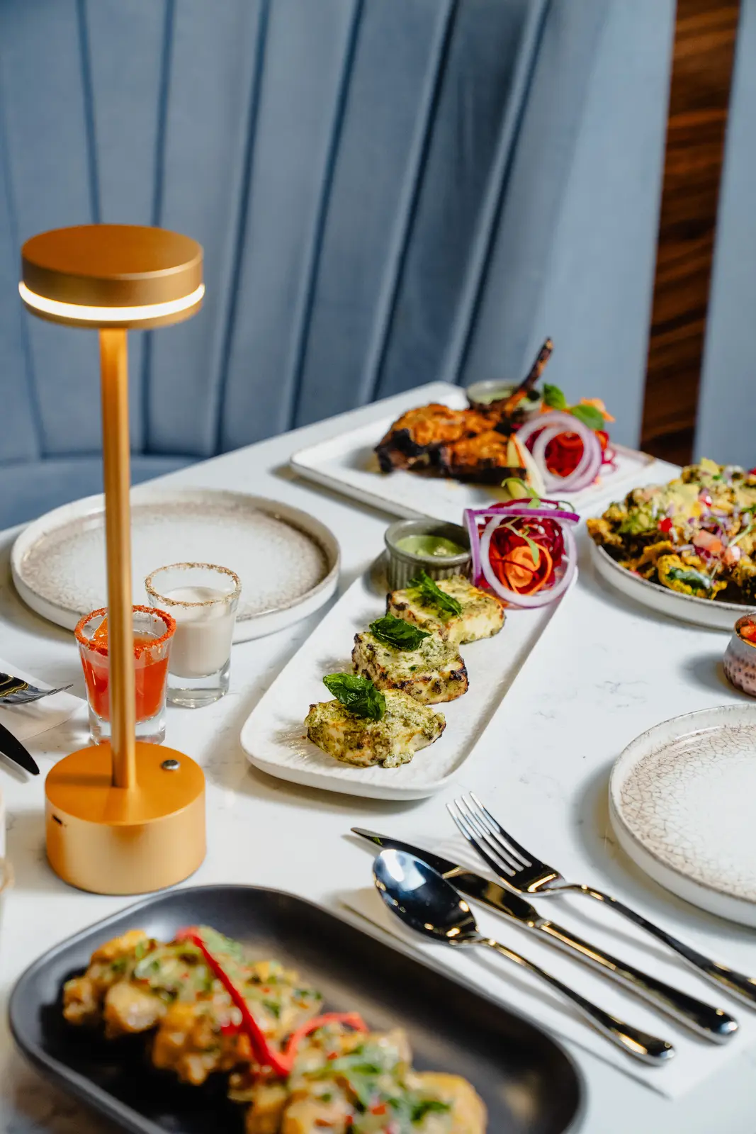 A full table spread of modern Indian dishes